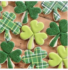 decorated shamrock cookies on a wooden table