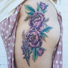 a woman's back with flowers on it and polka dots around the bottom half