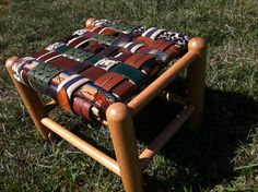 a wooden chair sitting on top of a lush green field