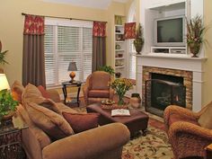 a living room filled with furniture and a flat screen tv mounted on the wall above a fireplace