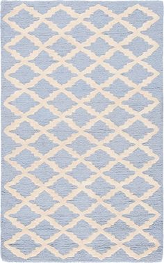 a blue and white rug with an abstract design