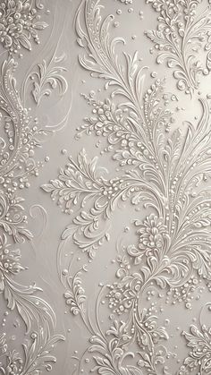 an ornate wallpaper with white flowers and leaves