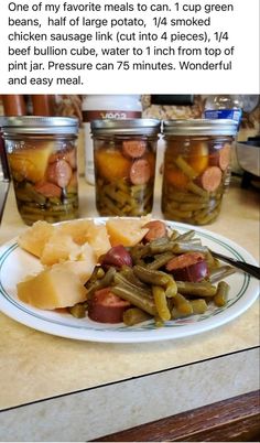 a white plate topped with green beans and pickles next to jars of canned food