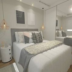 a white bed sitting in a bedroom next to two mirrors