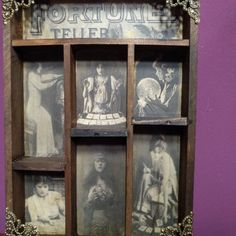 an old fashioned wooden shelf with pictures in it's glass inserts on purple wall