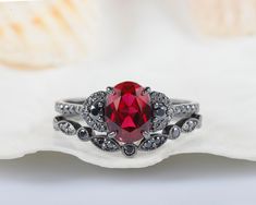 a close up of a ring with a red stone