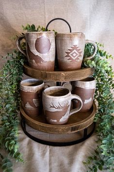 a three tiered tray with coffee cups on it