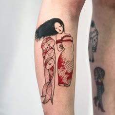 a woman's leg with a tattoo on it and an image of a mermaid holding a bottle