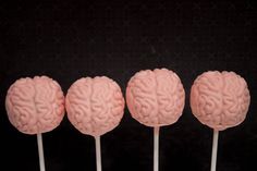 four brain shaped lollipops sitting on top of each other