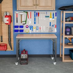 a workbench with tools hanging on the wall