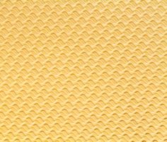 yellow textured paper with wavy lines on it