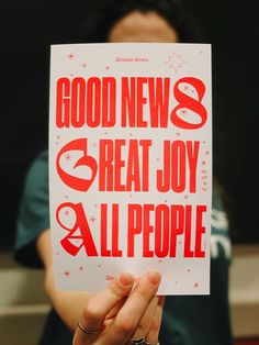 a person holding up a sign that says good news 3 great joy all people