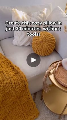 a living room with white couches and yellow accessories on the coffee table next to it