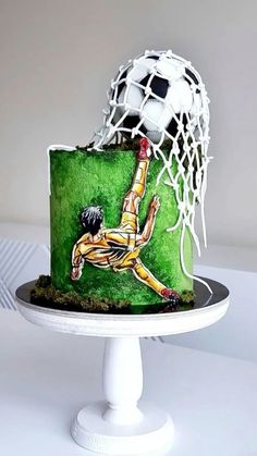 a cake with a soccer goalie on it and a ball coming out of the net