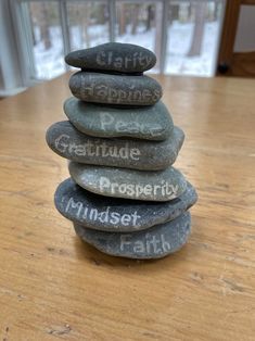 a stack of rocks with words written on them