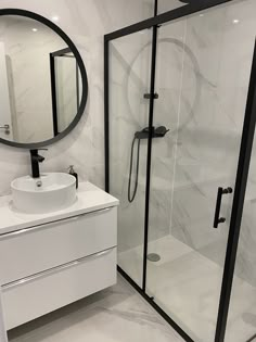 a bathroom with a sink, mirror and stand up shower stall in the middle of it