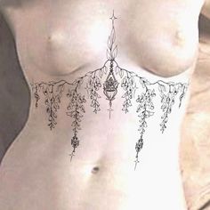 a woman's stomach with tattoos on it