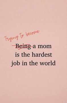 the words being a mom is the hardest job in the world on pink paper