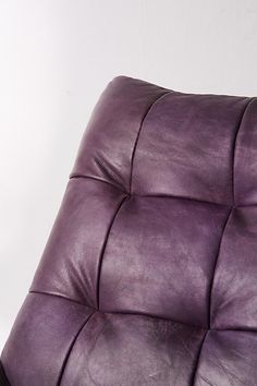 a close up of a purple leather chair