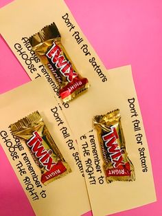 three pieces of candy bar sitting on top of a piece of paper with some writing on it