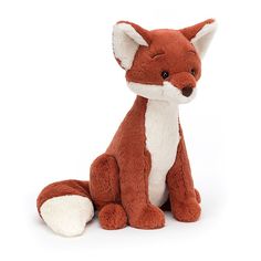 a small stuffed fox sitting on the ground