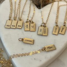 "Personalized Gold Rectangle Pendant Necklace from our Memoirs Made Collection. Personalize a short word or up to three initials on the lovely 14k gold filled tag necklace Free Engraving for a limited time! NECKLACE DETAILS * 14k gold-filled or 925 sterling silver * Matching cable chain in your choice of 16\", 18\" or 20\" length * Tag measures 13.5mm x 6mm (.53\" x .23\") * Spring ring clasp closure * Choice of several fonts and design layouts * 1 - 3 characters will fit across the tag, we can Personalized Yellow Gold Necklaces For Anniversary, Personalized Yellow Gold Necklace For Anniversary, Rectangular Initials Jewelry For Personalized Gift, Rectangular Initials Jewelry For Anniversary, 14k Gold Filled Yellow Gold Charm Necklace For Anniversary, Custom Name 14k Gold Jewelry, Personalized Rectangular Initials Jewelry, Gold Rectangular Initial Necklace For Personalized Gift, Gold Custom Name Charm Necklace For Valentine's Day