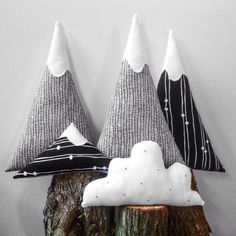 three small trees are sitting on top of each other in the shape of snow cones