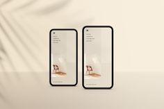 two cell phones with images on them sitting next to each other in front of a white wall