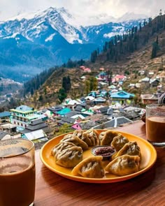 a plate of food on top of a wooden table next to a cup of coffee