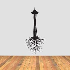 a room with a wooden floor and a clock tower on the wall above it that has roots growing out of it