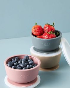 two bowls filled with blueberries and strawberries on top of each other next to one another