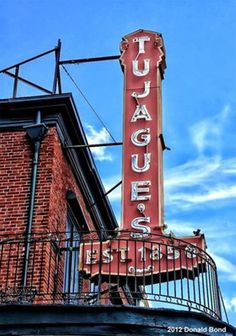 a red sign that reads fudgers on the side of a building