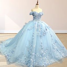 Step into a fairy tale with the Sky Blue Lace Princess Quinceanera Dress Ball Gown. This enchanting gown features a voluminous ball gown silhouette and is crafted from soft tulle for a light, ethereal feel. The stunning sky blue color adds a sense of serenity and elegance. The off-the-shoulder neckline and sleeveless design offer a flattering yet romantic touch, drawing attention to your shoulders and neckline. The corset back ensures a perfect, tailored fit, allowing you to feel both comfortabl Light Blue And White Quinceanera Dresses, Cinderella Dress Quinceanera, Baby Blue Quince Dresses, Wedding Dress Light Blue, Baby Blue Quinceanera Dresses, Sky Blue Gown, Sky Blue Quinceanera Dresses, Light Blue Quinceanera Dresses, Baby Blue Quinceanera