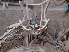 a wooden chair sitting on top of a pile of rubble