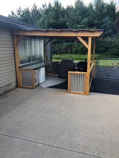 an outdoor living area with a grill and bbq