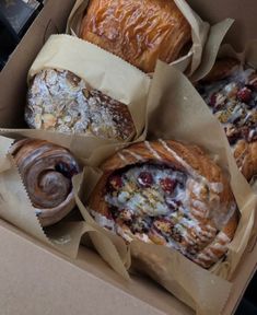 several pastries are in a box on the table