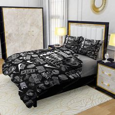 a bed with black and white designs on the comforter is shown in this image