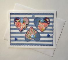 two cards with hearts on them sitting next to each other