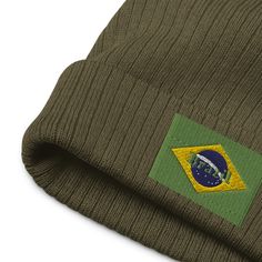 Show off your Brazilian pride in style with these Brazil Beanies! This premium quality beanie features an embroidered Brazil flag on the front and is available in 8 different vibrant colours. Made from a blend of 50% recycled polyester and 50% acrylic. Whether you're hoping to stay warm in the winter or just express your passion for Brazil in the summer, the Beanie has got you covered. View more Brazil items + Features + High quality Embroidered Brazil flag on the front 8 vibrant color options 5 Brazil Flag, Porto Rico, Costume Intero, Vibrant Colours, Retro Stil, Rash Guard, Style Retro, Gothic Fashion, Beanie Hats