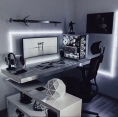 a desk with a computer monitor, keyboard and headphones on it in a room