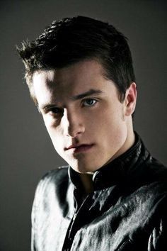 a young man with blue eyes and a leather jacket