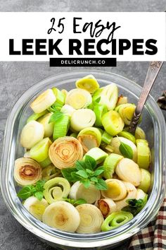 a glass bowl filled with leeks on top of a table