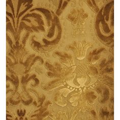 a gold and brown wallpaper with an ornate design on it's surface,