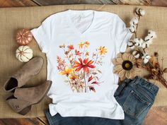 This beautiful Watercolor Fall Leaves T Shirt is great for fall or anytime you need an artistic reminder that change is beautiful! The design features a beautiful arrangement of watercolor leaves. Purchase for yourself or as a gift for your favorite autumn or nature lover. This soft jersey tee is comfortable enough to wear all day long. High quality print will make it an instant favorite in every wardrobe. .: 100% airlume combed and ringspun cotton (fiber content may vary for different colors) .: Light fabric (4.2 oz/yd² (142 g/m .: Retail fit .: Sewn in label .: Runs true to size ABOUT THIS PRODUCT *Bella + Canvas brand t-shirt *You are purchasing the t-shirt only, props used in photos are NOT included with purchase SIZING *The photos include a size chart *Sizes are adult unisex sizes *La Womens Fall Shirts, Watercolor Fall Leaves, Change Is Beautiful, Girls Trip Gifts, Fall Shirts Women, Botanical Shirt, Fall Tee, Fall Gifts, Watercolor Leaves