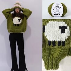 a woman is wearing a green sweater with black and white sheep on it, while standing next to a knitted hat