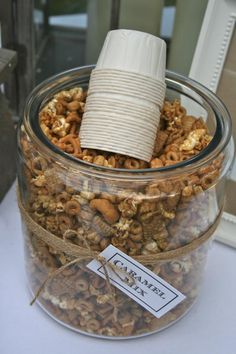 a glass jar filled with nuts on top of a table