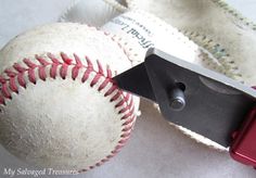 a pair of scissors cutting through a baseball