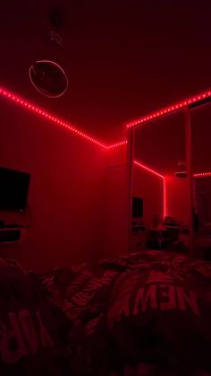 a bedroom with red lights on the ceiling