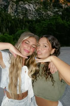 two young women posing for the camera with their arms around each other