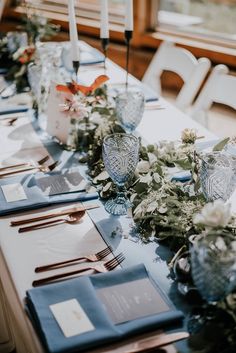 the table is set with place settings and silverware for an elegant dinner or reception